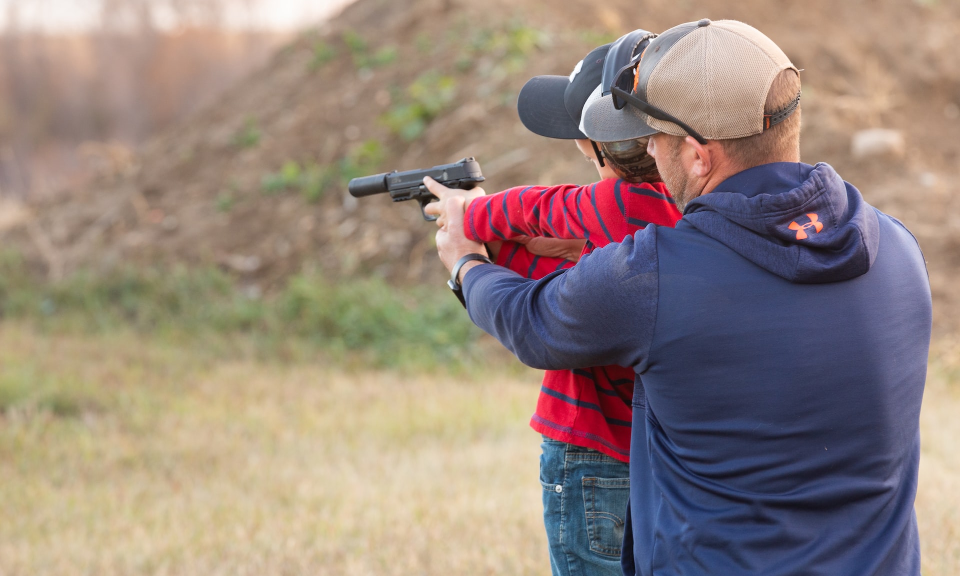 a man and a woman are aiming at a target